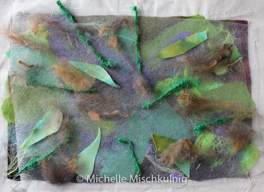 I then add a second layer of texture by laying another piece of fusible web on top of existing background.On top of the fusible web I place silk yarns,silk fibres and other fabrics and fuse together again.
